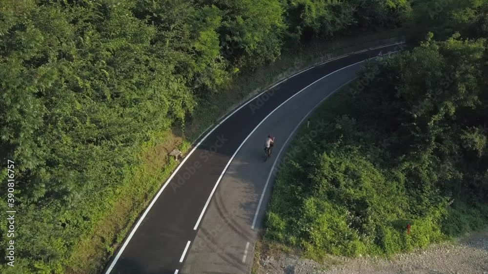 aerial of A Cyclist on a mountain road, losing something to stop, Italy aerial of A Cyclist on a mountain road, losing something to stop, Italy