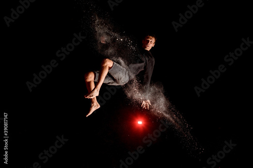 Young man having fun and jump high on trampoline