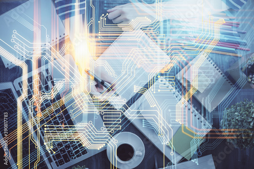 Double exposure of hands making notes with world map hologram and data theme icons. Concept of international network data.