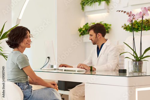 Doctor with a patient at the reception of the dental clinic.