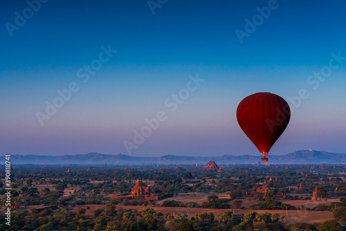 Sunset many hot air balloon with stupas in Bagan, Myanmar. Bagan is an ancient with many pagoda of historic buddhist temples and stupas. space for text. © Thirawatana
