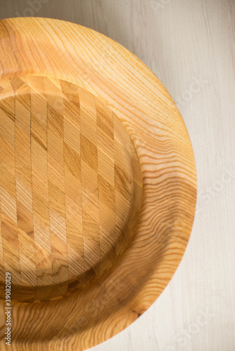 Wooden plate on a white table. National dishes. Crockery made from natural materials. Wood texture