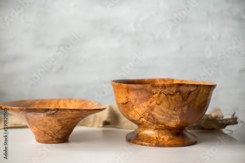 Wooden plate on a white table. National dishes. Crockery made from natural materials. Wood texture