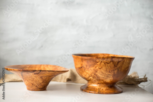 Wooden plate on a white table. National dishes. Crockery made from natural materials. Wood texture