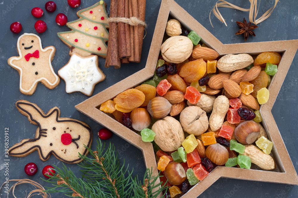 Christmas nuts and dried fruit mix in star-shaped bowl assortment of delicacies and cookies