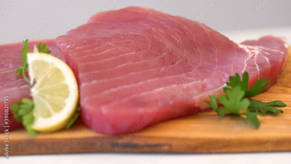 fresh and raw red tuna fillet on wooden board fresh and raw red tuna fillet on wooden board