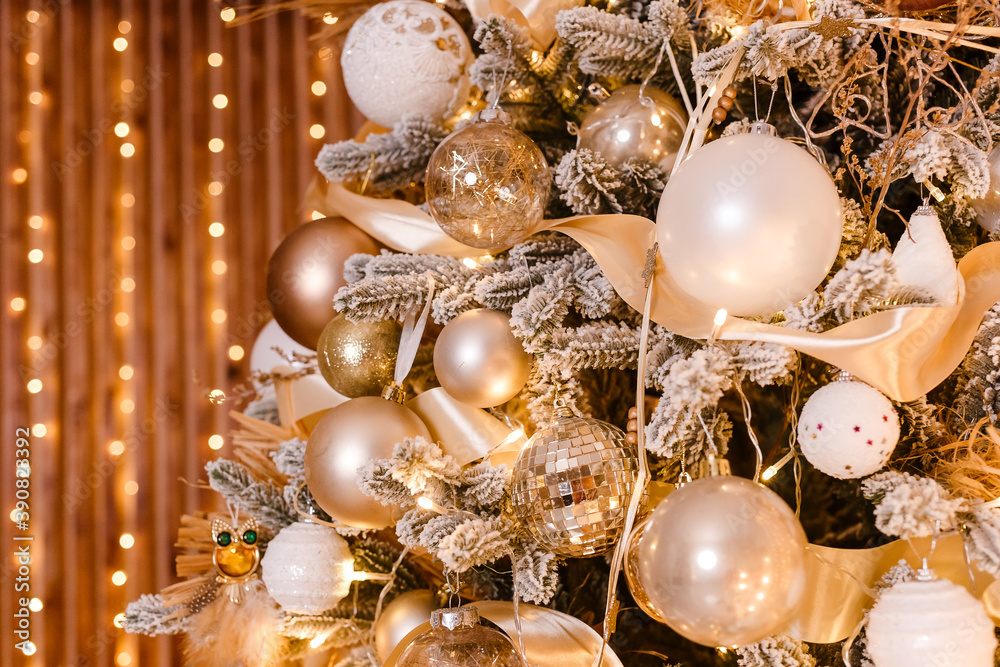 beautiful Christmas tree is close. Golden Christmas. golden and white balls on Christmas tree branches