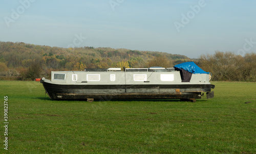 Old narrow boat in a field photo