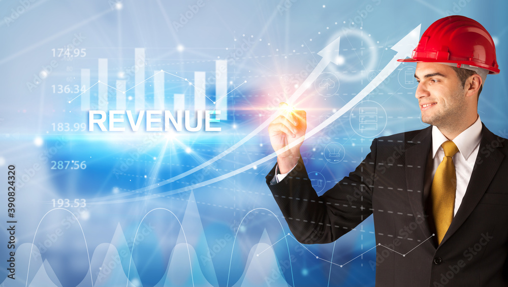 Young businessman with helmet drawing REVENUE inscription, modern business technology concept Young businessman with helmet drawing REVENUE inscription, modern business technology concept