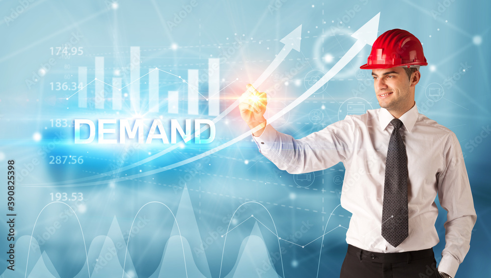 Young businessman with helmet drawing DEMAND inscription, modern business technology concept Young businessman with helmet drawing DEMAND inscription, modern business technology concept