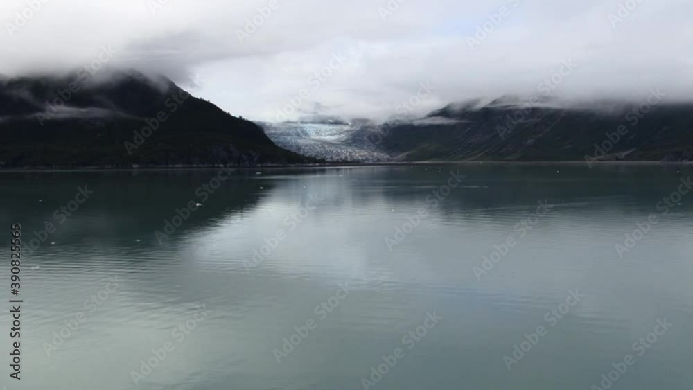 Wide shot of a glacier and the mountains in the Glacier Bay National Park,Alaska.Low clouds on the mountains Wide shot of a glacier and the mountains in the Glacier Bay National Park,Alaska.Low clouds on the mountains