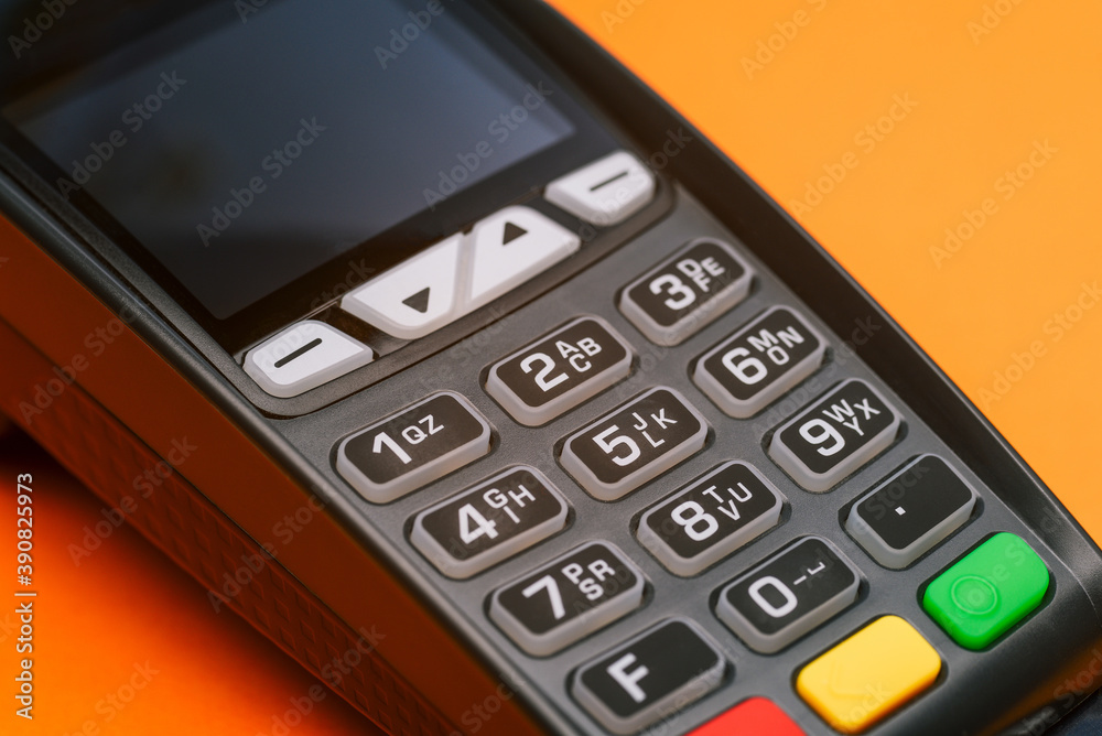 Close-up of a credit card machine. Contactless and cashless acceptance of payments by bank card or phone. Terminal for paying for purchases. Customer service