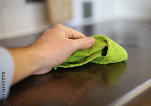 Photos cleaning the kitchen with a green cloth