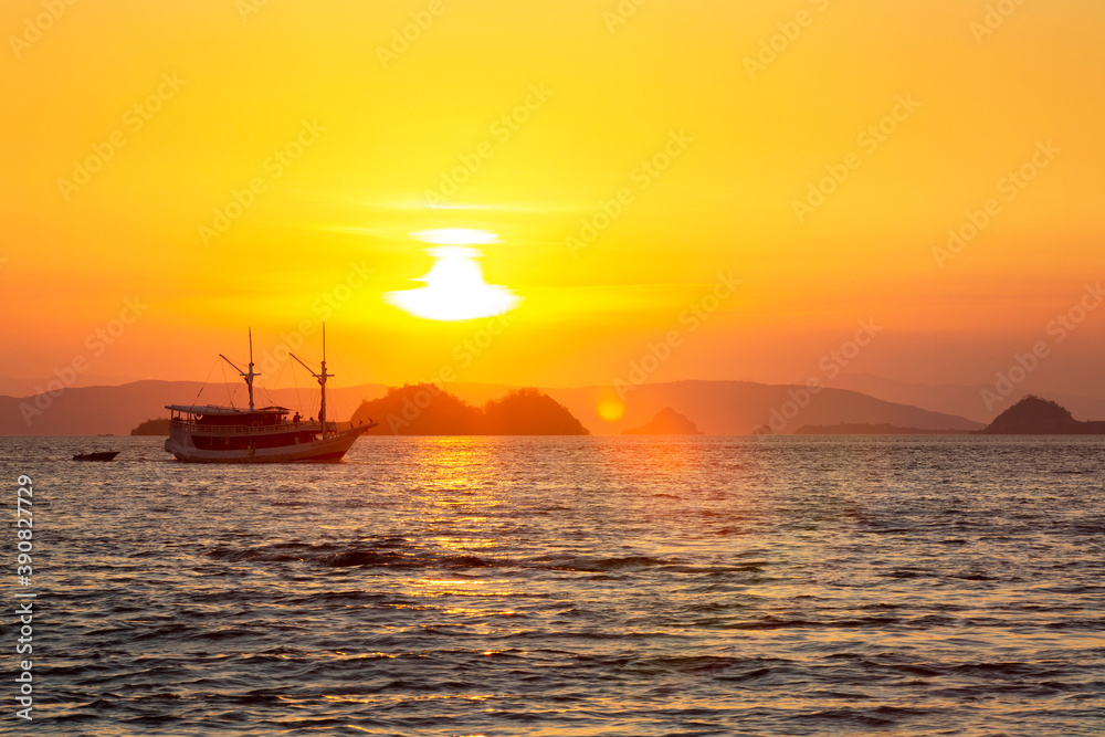 Sailboat at sunset on the sea around the Komodo islands, Indonesia
