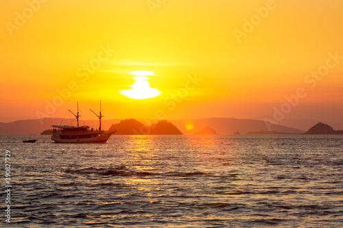 Sailboat at sunset on the sea around the Komodo islands, Indonesia