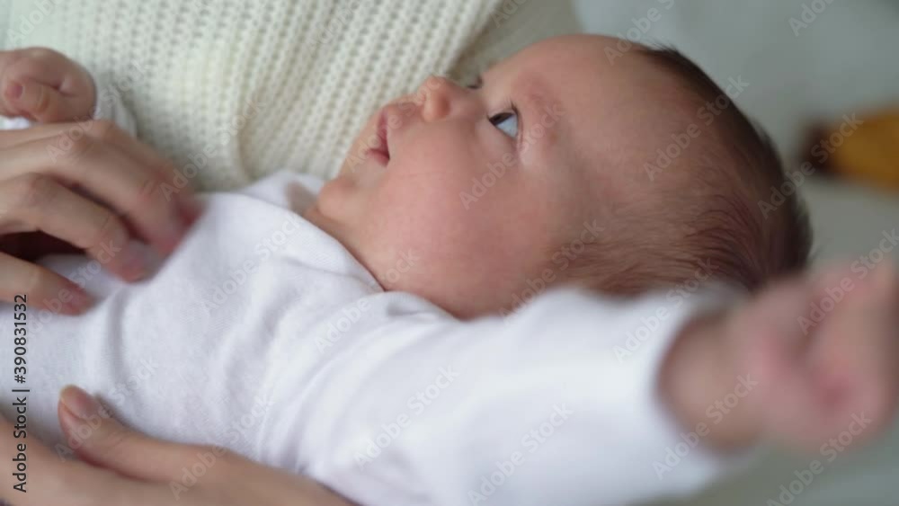a newborn baby is in mom's arms, women's hands are looking. Motherhood concept a newborn baby is in mom's arms, women's hands are looking. Motherhood concept