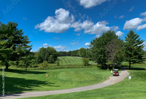 A green golf course and blue cloudy sky on a beautiful summer day in Canada