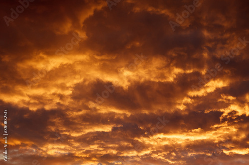 Colorful dramatic sky with orange clouds at sunset