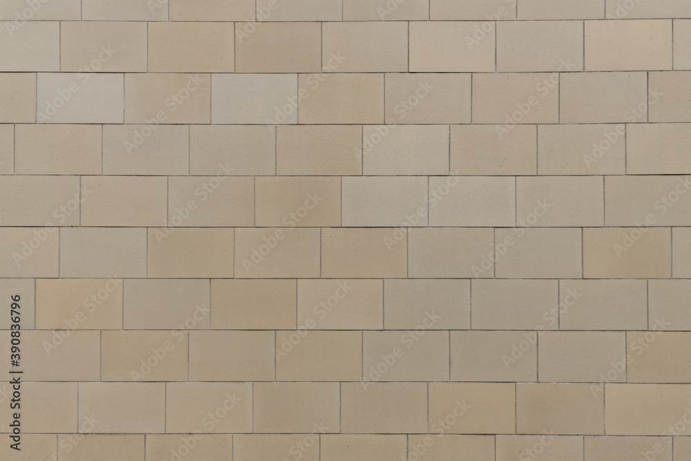 Fototapeta premium texture of a tiled beige stone wall as background