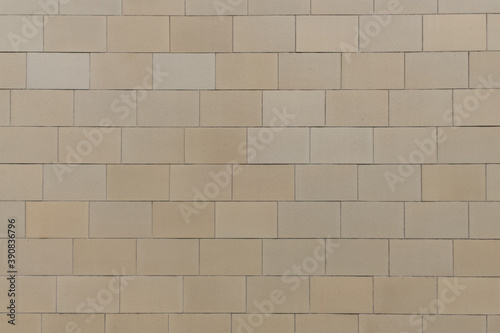 texture of a tiled beige stone wall as background