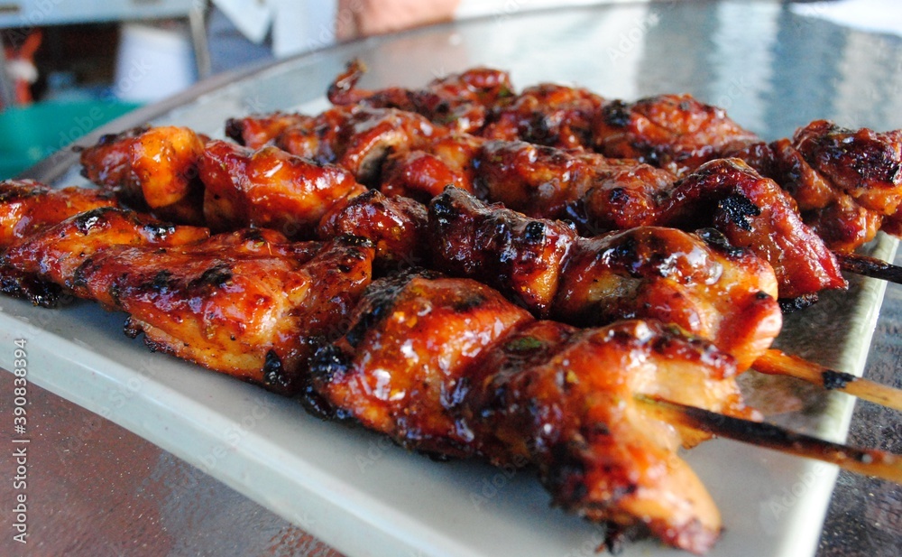 Juicy chicken slices barbequed in skewers Juicy chicken slices barbequed in skewers
