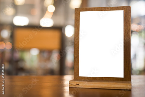 Menu with isolated white on wooden table on blurred restaurant background