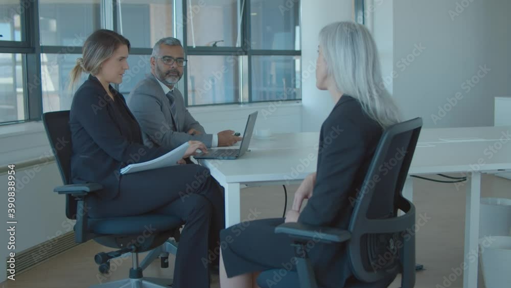 Fair haired female professional meeting and talking to employer and HR manager at job interview. Static shot. Human resource and career concept Fair haired female professional meeting and talking to employer and HR manager at job interview. Static shot. Human resource and career concept