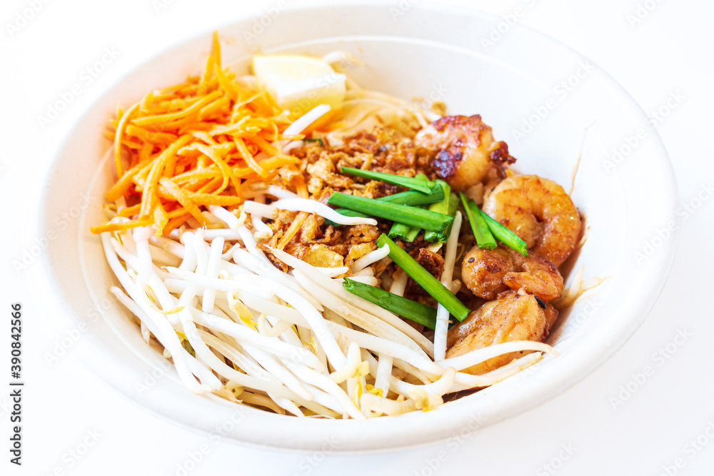 Asian dish Pad Thai prepared with noodles, grilled shrimps, soy sprouts, carrots pieces and sprinkle with peanuts to serve a delicious meal Asian dish Pad Thai prepared with noodles, grilled shrimps, soy sprouts, carrots pieces and sprinkle with peanuts to serve a delicious meal