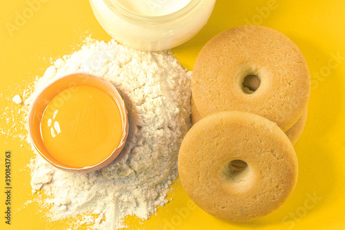biscotti con latte, farina e uova su sfondo giallo