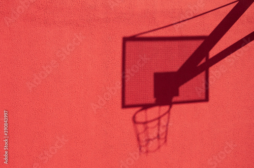 basketball hoop shadow on the red wall. High quality photo