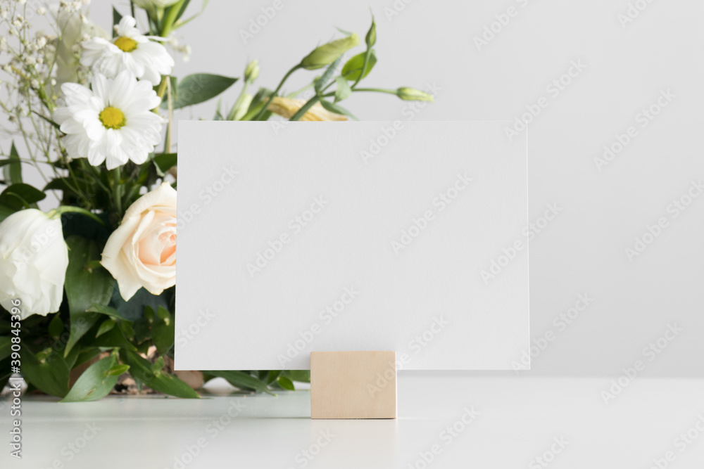 Wedding table number card mockup with a floral arrangement.