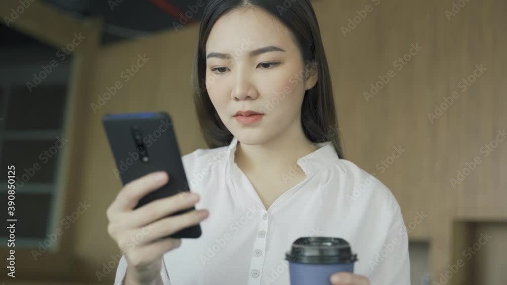 Asian woman watching on mobile phone, 4k hand held video. Asian woman watching on mobile phone, 4k hand held video.
