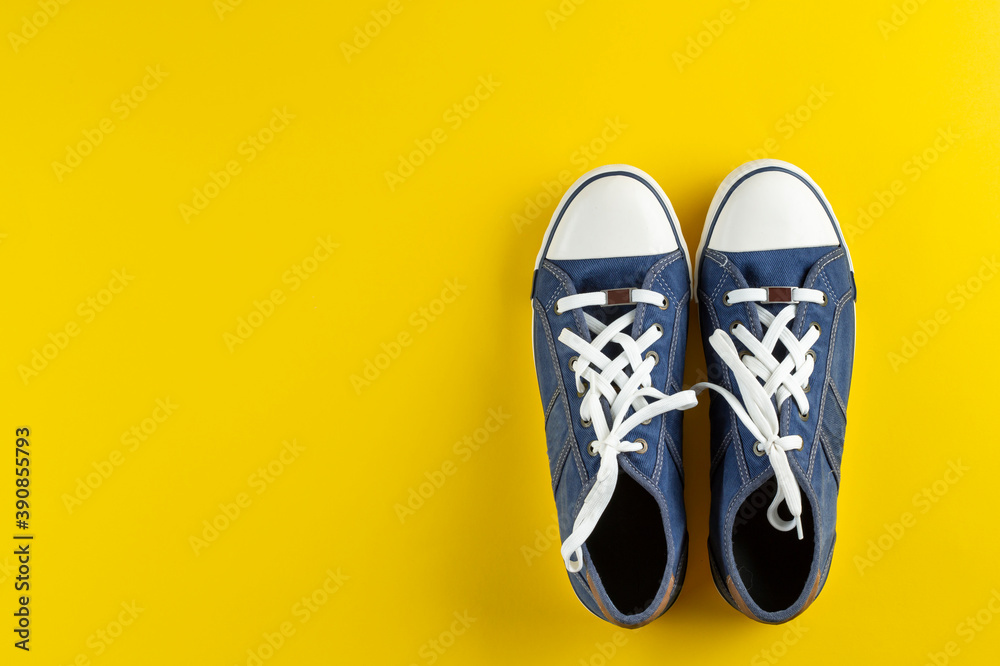 New blue gumshoes on yellow background