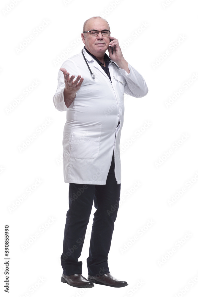 in full growth. Mature doctor reading a message on his smartphone in full growth. Mature doctor reading a message on his smartphone