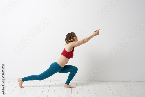 woman in leggings is engaged in gymnastics in a light room slim figure fitness sport