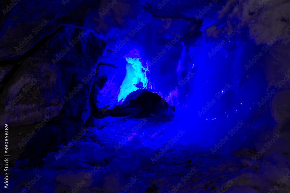 KUNGUR, RUSSIA - JANUARY 5, 2016. Illuminated with blue color an ice sculpture in the cave.