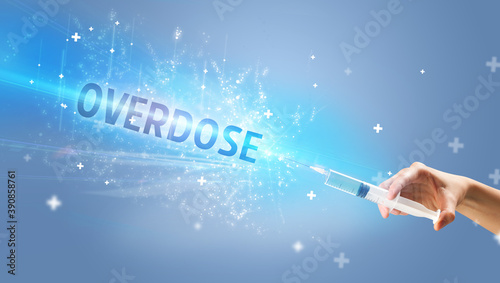 Syringe, medical injection in hand with OVERDOSE inscription, medical antidote concept