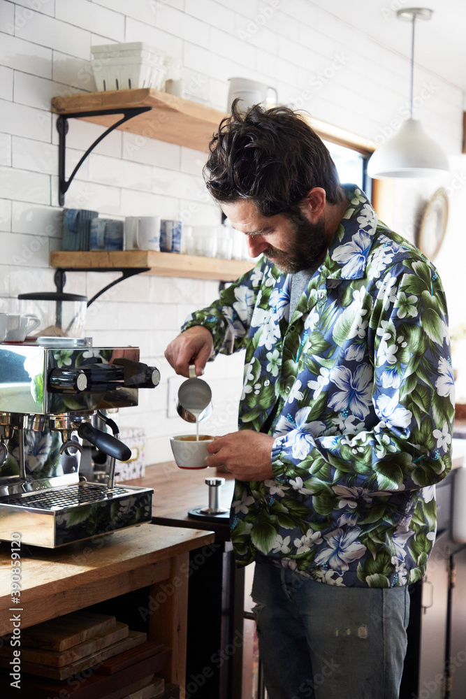 Man making cappuccino at home in kitchen Man making cappuccino at home in kitchen