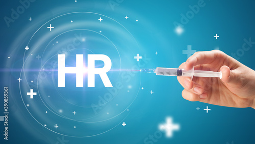 Syringe needle with virus vaccine and HR abbreviation, antidote concept photo