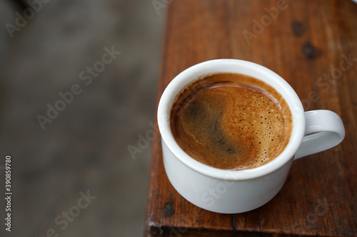 A cup of coffee on a wooden table 
