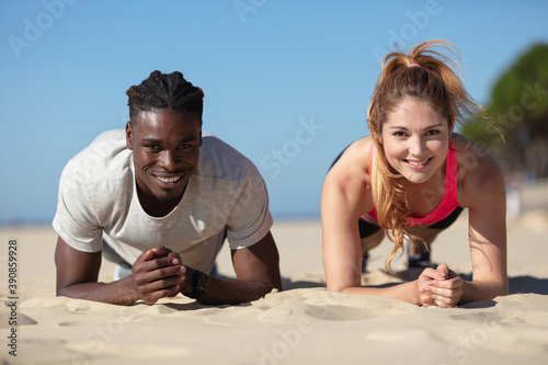 fit couple doing intense workout on beach