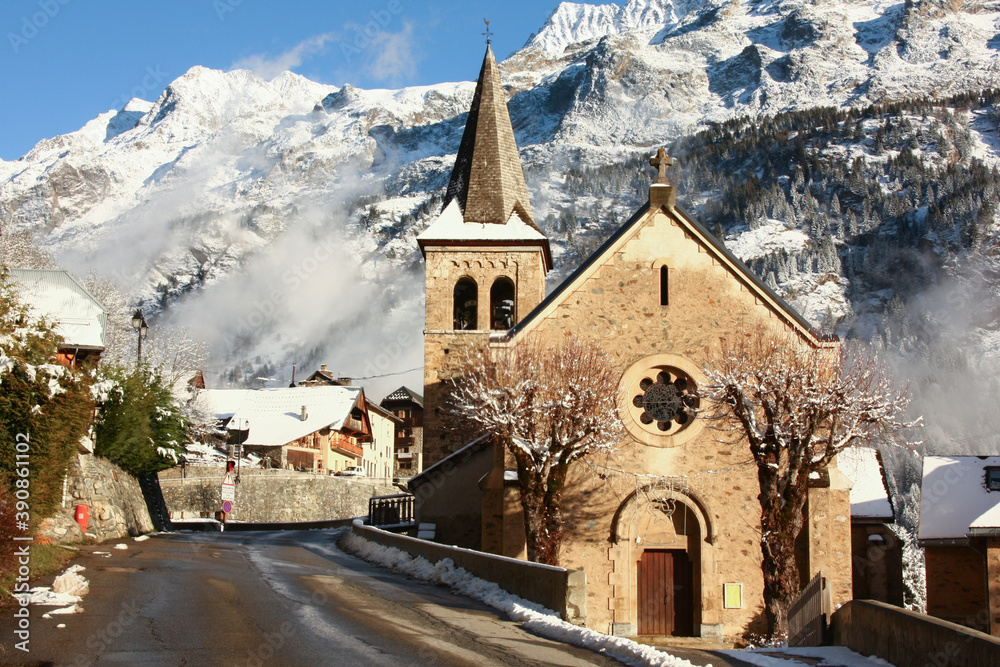Gorgeous winter scene of an old stone church in the Oisans region in the department of Isère in the French Alps
