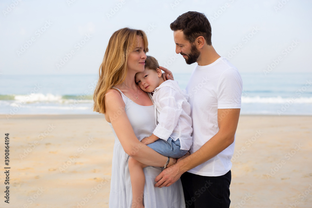 Portrait of a happy young family with a child on a tropical beach. India Portrait of a happy young family with a child on a tropical beach. India