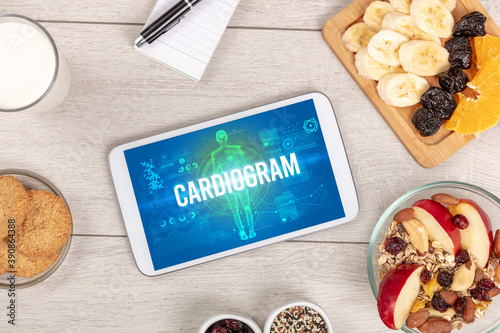 CARDIOGRAM concept in tablet with fruits, top view
