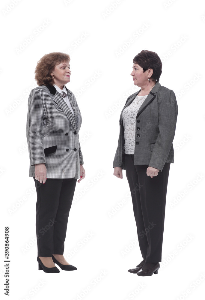in full growth. two mature women striding forward in full growth. two mature women striding forward