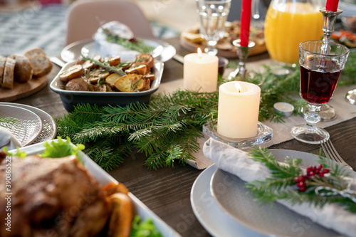 Part of festive table served with jug of orange juice, roasted potatoes, turkey