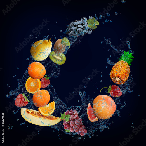 Fototapeta Naklejka Na Ścianę i Meble -  Panorama with fruits in splashes of water - juicy grapes, kiwi, melon, orange, strawberry, grapefruit, pineapple a delicious dessert for the festive table