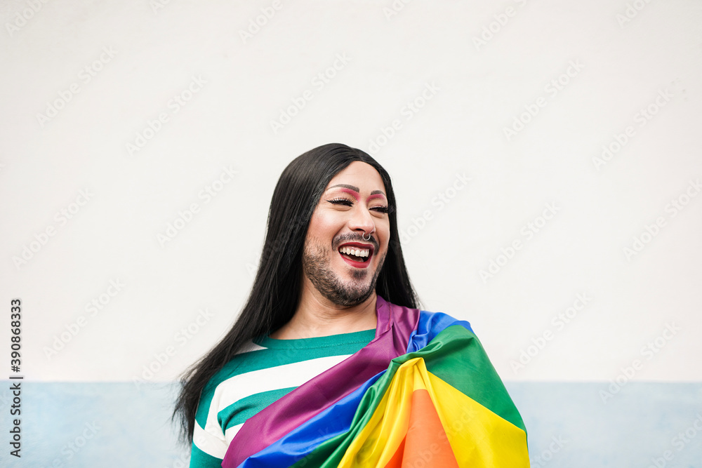 Drag queen with lgbt rainbow flag laughing - Concept of gay pride event and transgender - LGBTQI Drag queen with lgbt rainbow flag laughing - Concept of gay pride event and transgender - LGBTQI