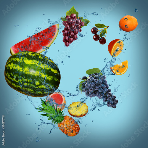 Fototapeta Naklejka Na Ścianę i Meble -  Panorama with fruits in splashes of water - juicy cherries, oranges, grapes, pineapple, grapefruit, watermelon are full of vitamins and are very useful for our health