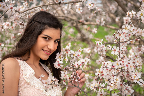 Attractive beautiful lady, dressed in pink clothing and plum blossom flowers in spring.